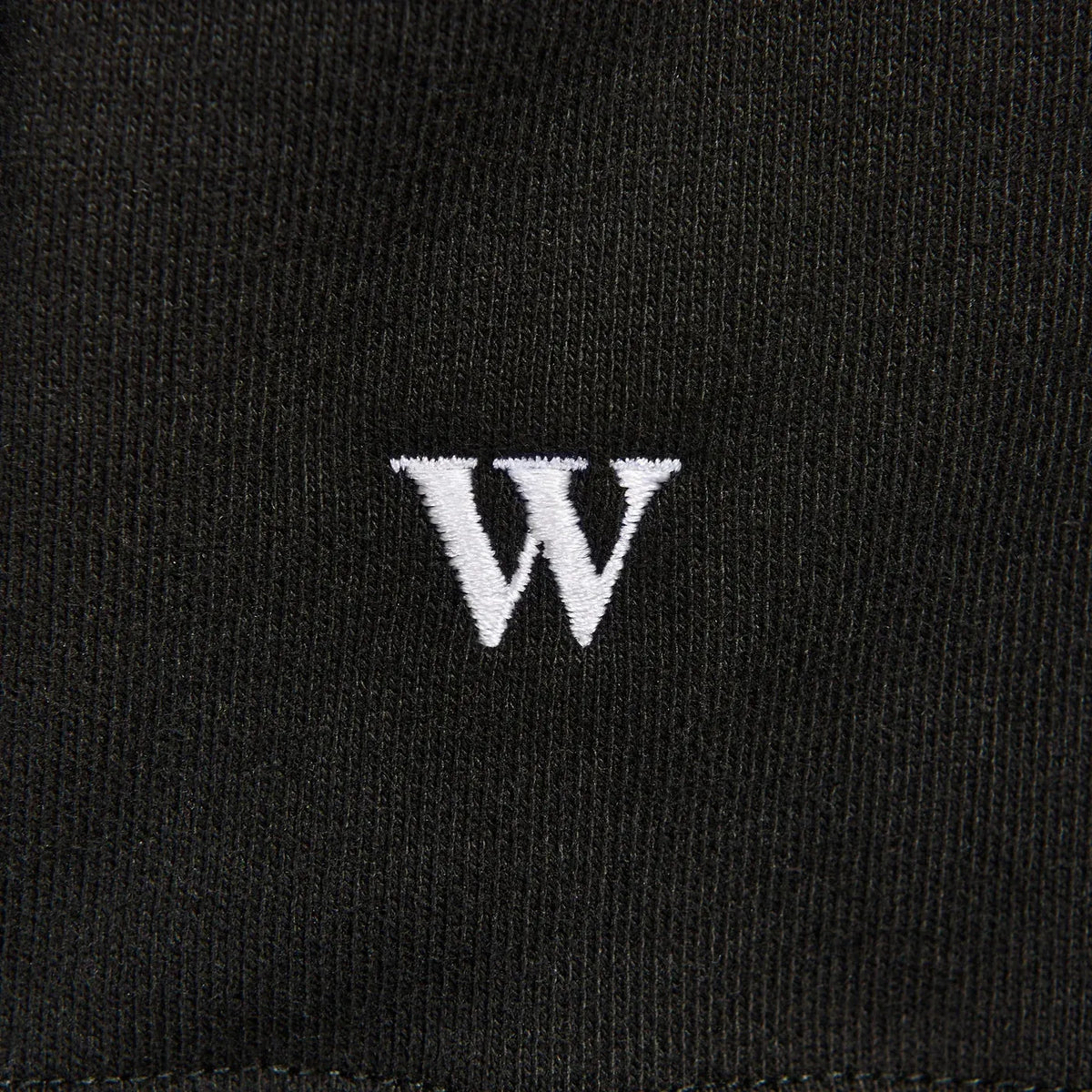 A black crewneck sweater with the words “Hot commodity” written on its chest.
